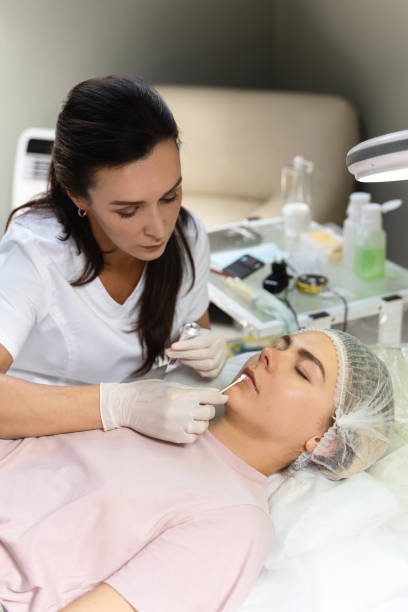 istock Professional permanent make-up artist applying anesthetic cream 1363678894