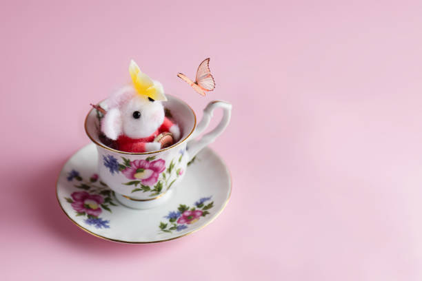 istock Woolly mouse in the cup plays with the butterfly 1363679022