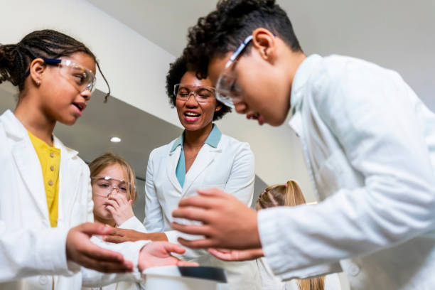 istock Diverse schoolchildren with teacher work together on science project 1363681761