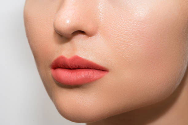 istock Female lips after permanent make-up lip blushing procedure 1363681844