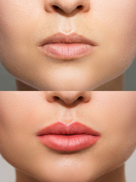 Female lips after permanent make-up lip blushing procedure stock photo