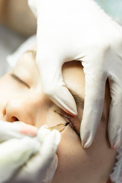 istock Young woman during professional permanent makeup treatment 1363681988