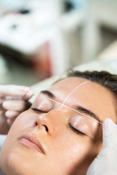 istock Woman during professional eyebrow mapping procedure 1363682028