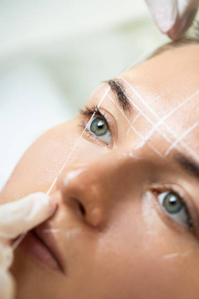 istock Woman during professional eyebrow mapping procedure 1363682159