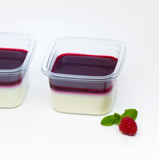 istock Panna Cotta dessert with raspberry jelly served in plastic boxes for catering on the white 1363682200