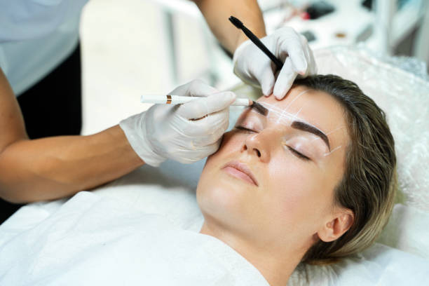 istock Woman during professional eyebrow mapping procedure 1363682825