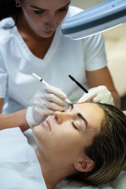 istock Woman during professional eyebrow mapping procedure 1363682896