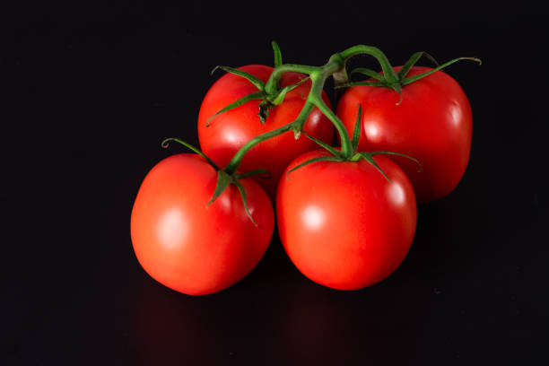 istock Fresh organic tomatoes on black background. Ripe red tomato. 1363682947