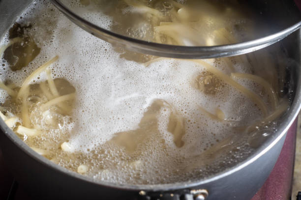 istock Cooking spaghetti in a pot with boiling water,simple kitchen 1363683035