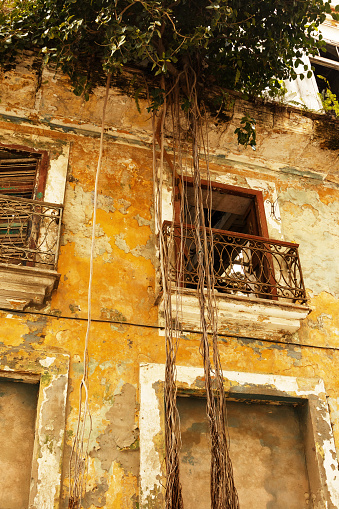 Old overgrown residential building in Havana city slums