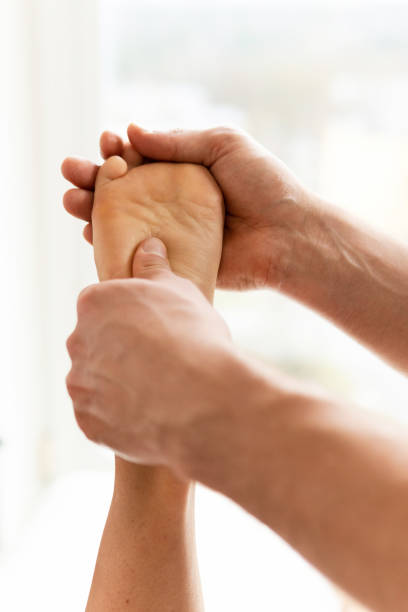 istock Masseur man during female foot massage 1363687006