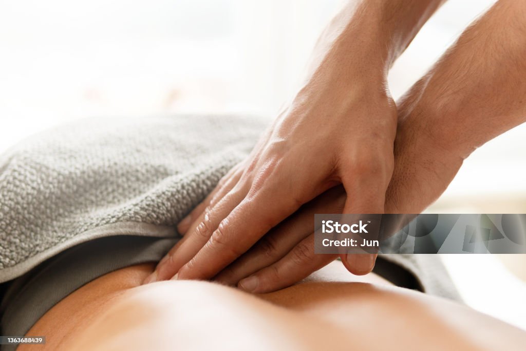 Closeup of masseur man's hands during back massage for young woman Closeup of masseur man's hands during back massage for his woman client Massaging Stock Photo