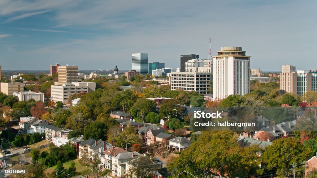 Drone Flight Over Columbia, SC Aerial shot of Columbia, South Carolina from over the Five Points neighborhood, looking across the rooftops and the University of South Carolina campus towards downtown office towers and the state house. South Carolina Stock Photo