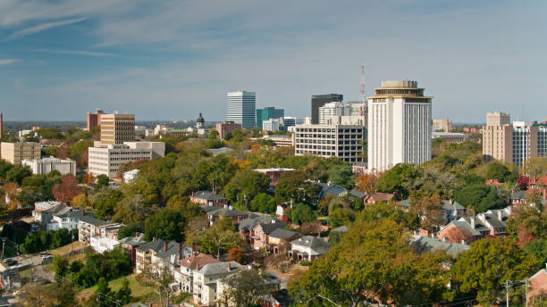 Drone Flight Over Columbia, SC Aerial shot of Columbia, South Carolina from over the Five Points neighborhood, looking across the rooftops and the University of South Carolina campus towards downtown office towers and the state house. south carolina stock pictures, royalty-free photos & images