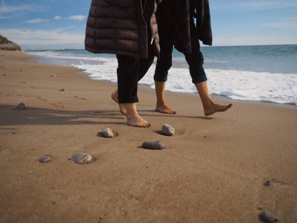 istock Two people walking in the beach. 1363691344