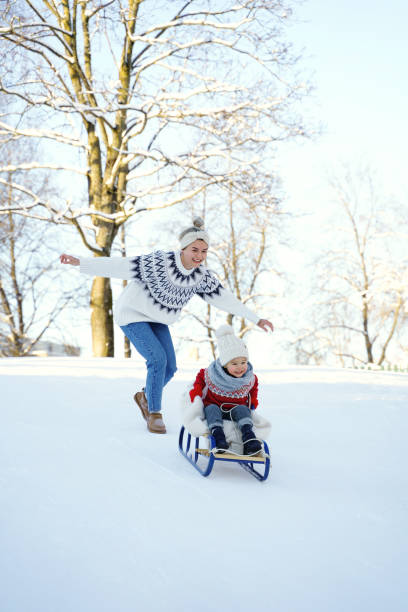 istock Mother and her cute little son having on a sledding hill 1363691473