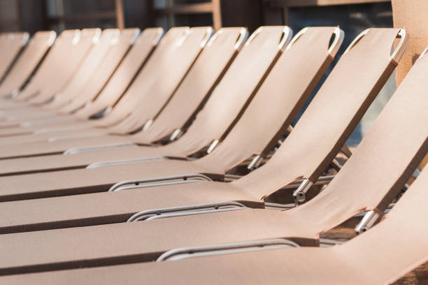 Multicolored wooden deck chairs on a large beach of wooden planks.