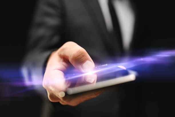 istock Businessman using mobile smartphone, closeup of hand tapping the touchscreen with thumb 1363693991
