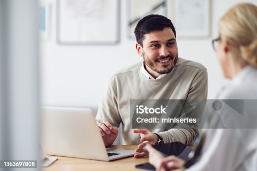 istock Home Office: Man and Woman Having a Meeting 1363697808