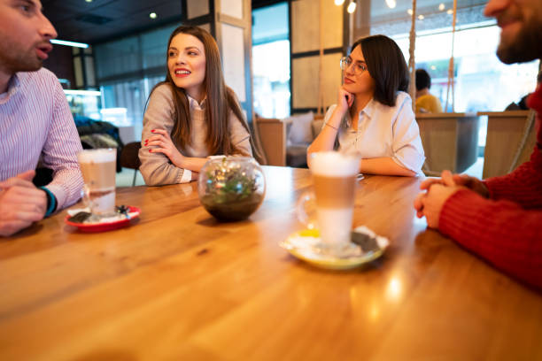 istock Young businesspeople sitting, talking, and drinking coffee 1363698731