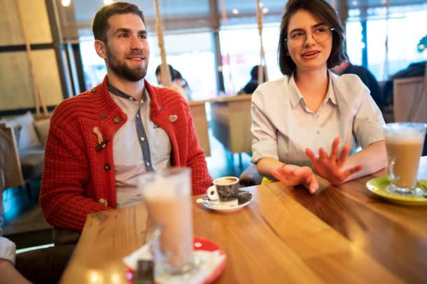 istock Smiling young couple in a coffee place 1363698748