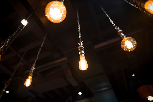 Low-angle view of a ceiling and decorative tungsten light bulbs.