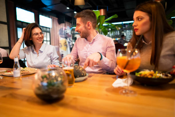 istock Smiling friends having lunch 1363698777