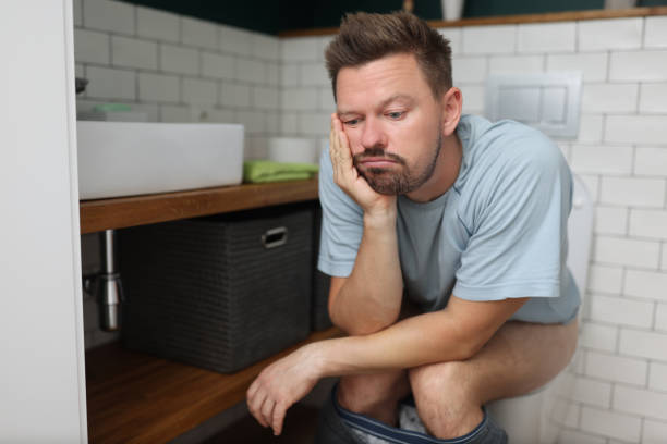 istock Bored man on toilet seat dream about something, fulfill natural need 1363699054