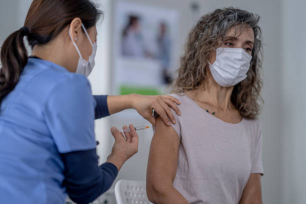 istock Woman gets booster shot 1363699208
