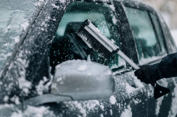 istock Man cleaning car from snow and ice 1363699256
