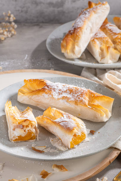 istock Typical portuguese sweets Pasteis de Vouzela served on countertop. Filo pastry with egg cream filling 1363700475