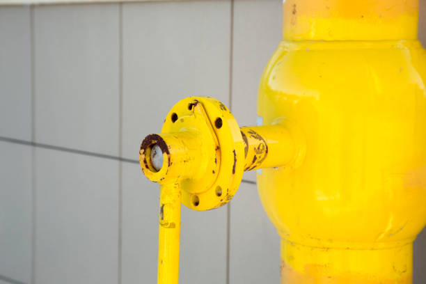 Los Angeles, California, USA - August 5, 2013: A Fireman bends as he removes a fire hose from an open city hydrant.
