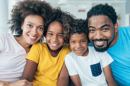 Portrait of happy family with children looking at camera
