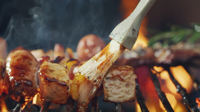 Macro shot of fresh juicy meat is grilling on a barbeque on a high flame. Concept: food, friends, holiday, tradition, relax