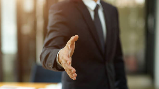 istock A business man in formal suit posting a greeting hand or shaking hand 1363717610