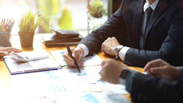 istock Two of businessmen working on financial data report together 1363717614