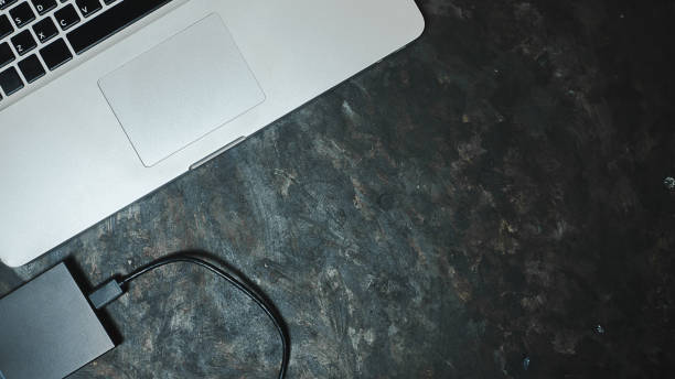 istock computer laptop and hdd on black background topview 1363718492