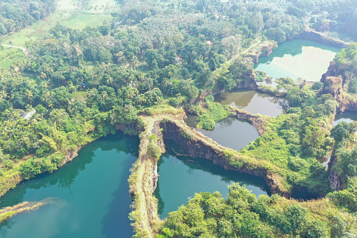 Aerial view of an abandoned quarry filled with rain water