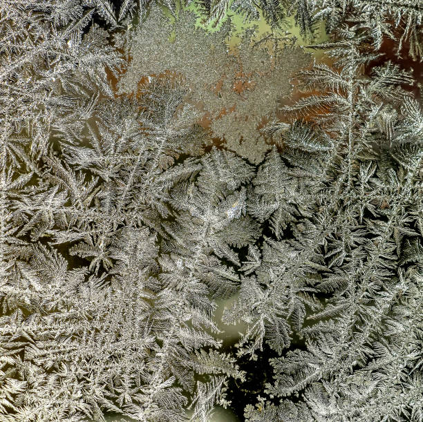 istock beautiful frosty patterns on the window glass 1363725253
