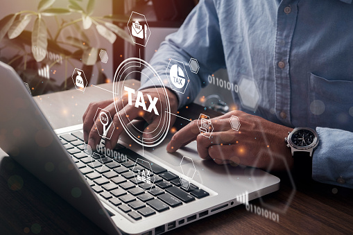 Businessman using a computer to Data analysis, paperwork, financial research, report. Calculation tax return. complete Individual income tax return form online for tax payment. Government, state taxes.