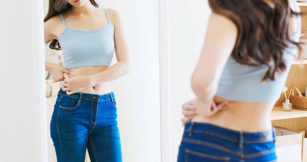 istock asian woman looks in mirror 1363726770