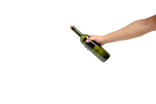 istock Empty, green, glass wine bottle in hand on a white background, isolate. 1363730993