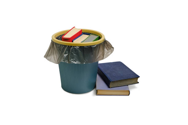 istock Trash can and the books thrown into it, on a white background, are isolated. 1363731003
