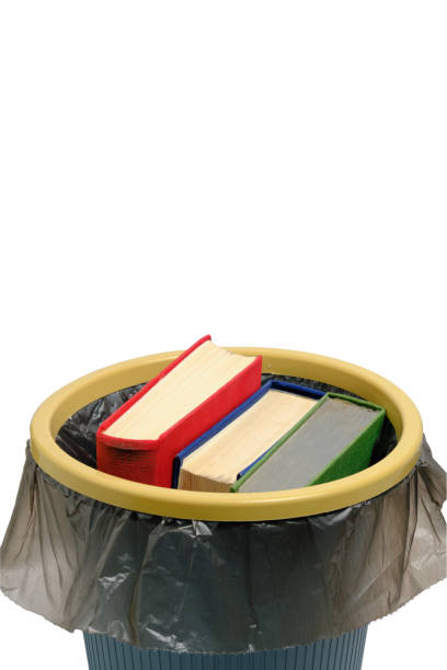 istock Trash can and the books thrown into it, on a white background, are isolated. 1363731004