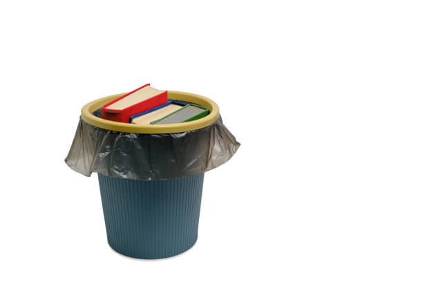 Trash can and the books thrown into it, on a white background, are isolated