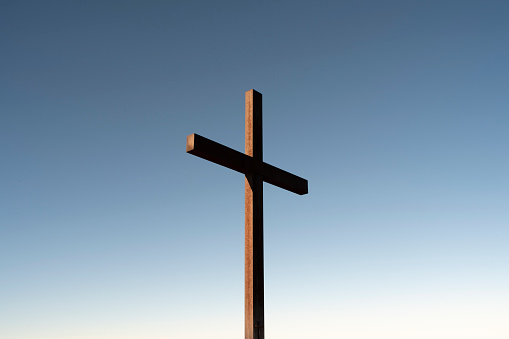 Christian iron cross on a blue sky