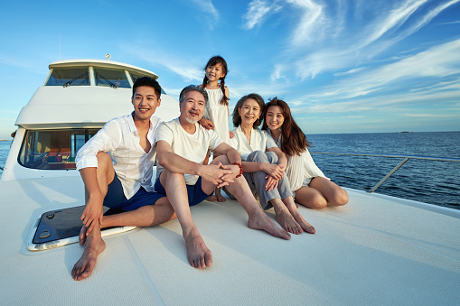 Family enjoying summer vacation on luxury yacht.