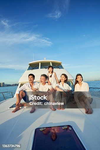 istock Happy family aboard a yacht out to sea 1363734796