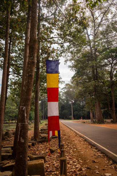 istock The Buddhist flag hang on the tree in the Angkor Thom park. 1363735998