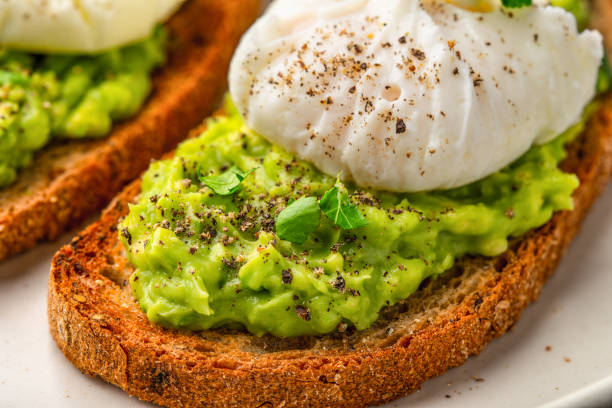 istock Avocado toast with poached egg close up 1363736929